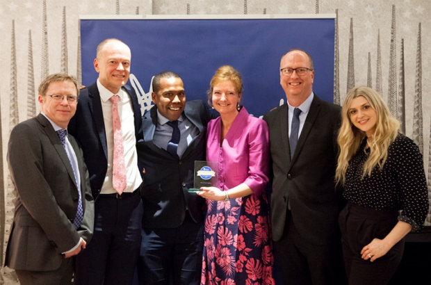 Photo of EA staff collecting the MIND wellbeing in the workplace gold award