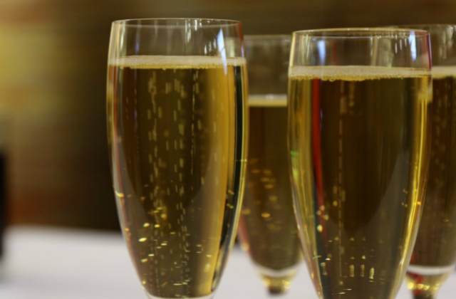 An image of two Champagne flutes of sparking wine