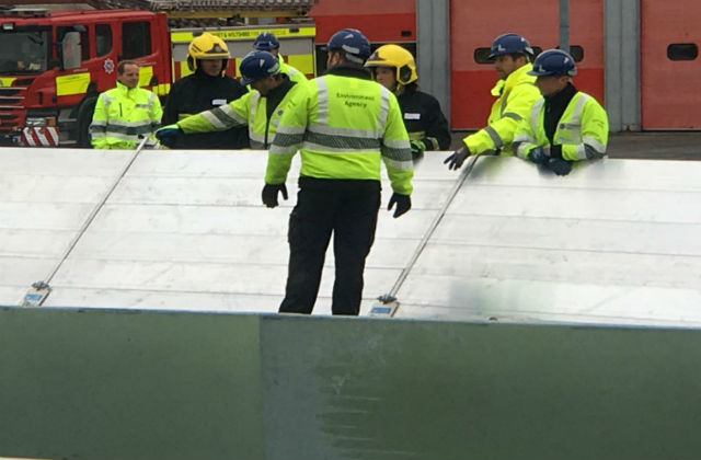 Environment Agency workers putting up flood barriers