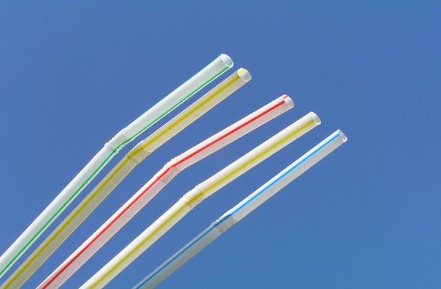 An image of five drinking straws against the blue sky.