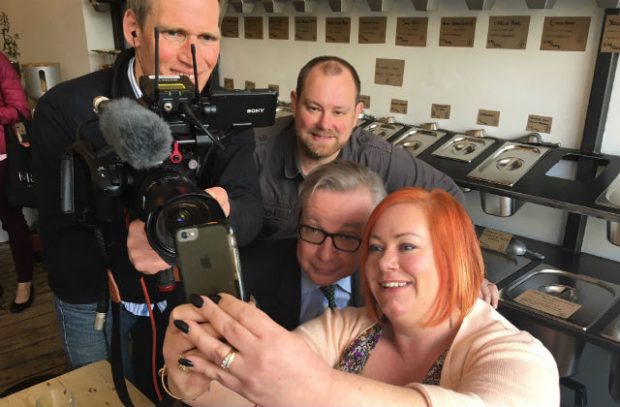 Secretary of State Michael Gove taking a selfie with a family.