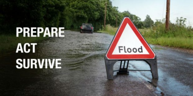 Image of a flood warning sign with says 'flood' with the caption prepare, act, survive.