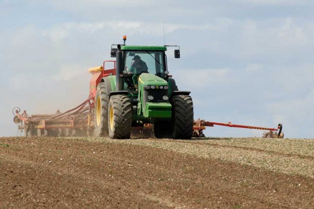 Picture of a tractor in a crop field