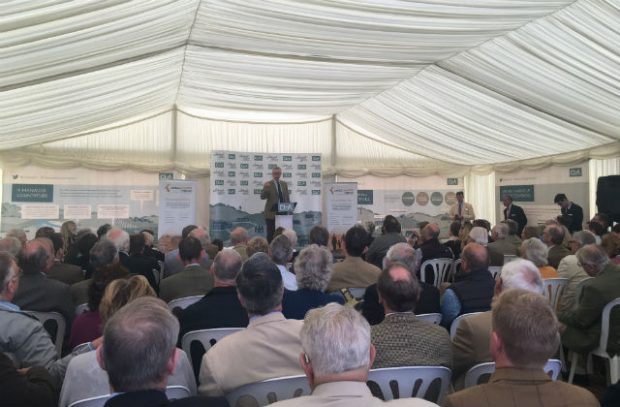 An image of Michael Gove, Enviroment Secretary, speaking to farmers at the Country Land & Business Association tent.