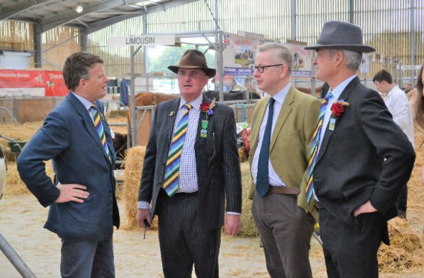 An image of Michael Gove, Enviroment Secretary, meeting with local representatives from the farming unions at the show.