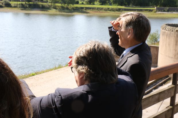 An image of minister coffey and David Rutley MP. They are looking at a lake.
