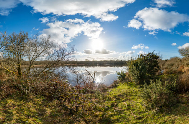 An image of crystal clear clouds above a lake.