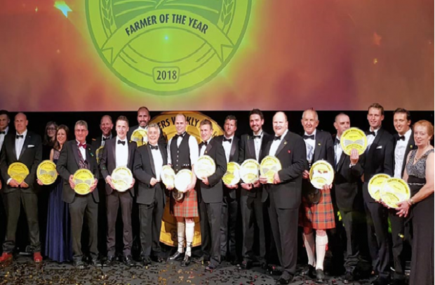 Image of winners standing holding their prizes at the Farmers Weekly Awards.