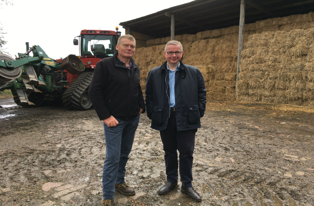 An image of the Secretary of State at a farm with Countryfile presenter Tom Heap.