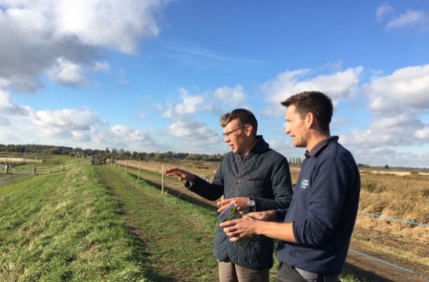 Julian Glover and Matt Gooch from the Suffolk Wildlife Trust in a field in the Broads.