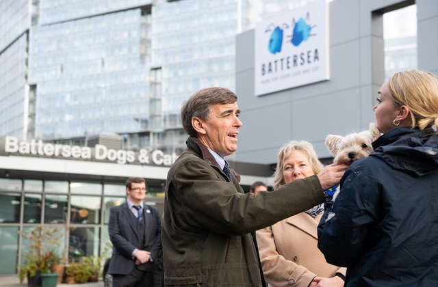 An image of Minister Rutley speaking to a group of people outside Battersea Dogs and Cats Home.