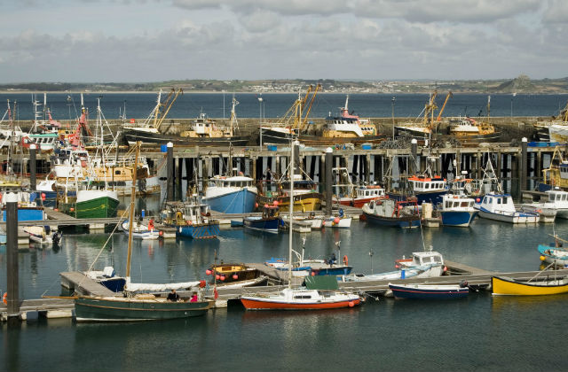 Image of a major fishing port, with boats at a harbour.