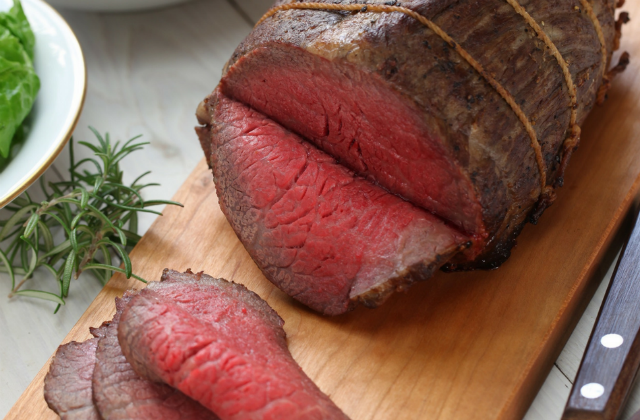 Picture of sliced beef on chopping board.