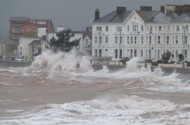 An image of high seas coming up against the Exmouth harbour.