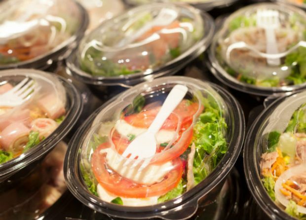 image of a salad in a plastic container with a fork