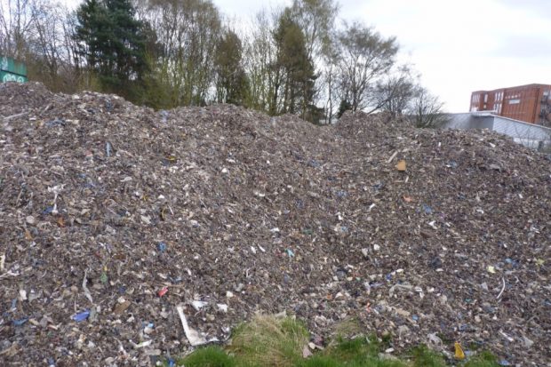 Image of 100 tonnes of waste outside a school