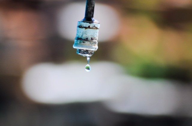 An image of water dripping from a tap.