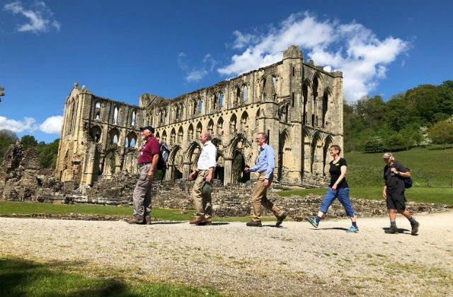 Image of Lord Gardiner and walkers by Rievaulx Abbey along the Cleveland Way National Trail