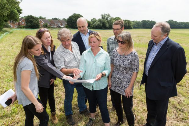 Photo of eight people stood in a field. From left to right the people are Jen Almond (District Level Licencing Project Manager, Natural England), Donna Popperwell (Bakerwell Consultants), Tony Juniper (Chair of Natural England), Paul Kitchingman (Operations Director, Barratt Homes), Kate Bull (Ken Project Manager, Natural England), Craig Thomas (Habitat Delivery Strategist, Natural England) Mel Hughes (Director, Change & Reform, Natural England), Nick Fenton (Chair, Kent Developers Group).