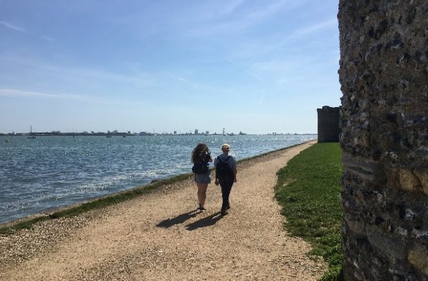 Two people walking along a path on the South Coast
