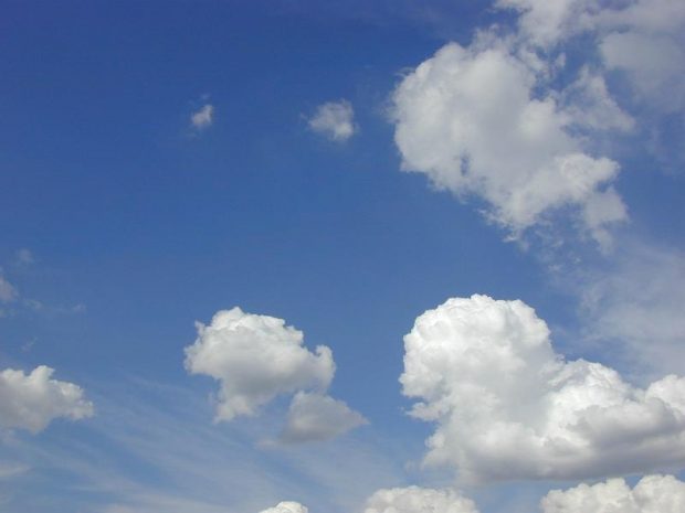 An image of blue sky with fluffy white clouds