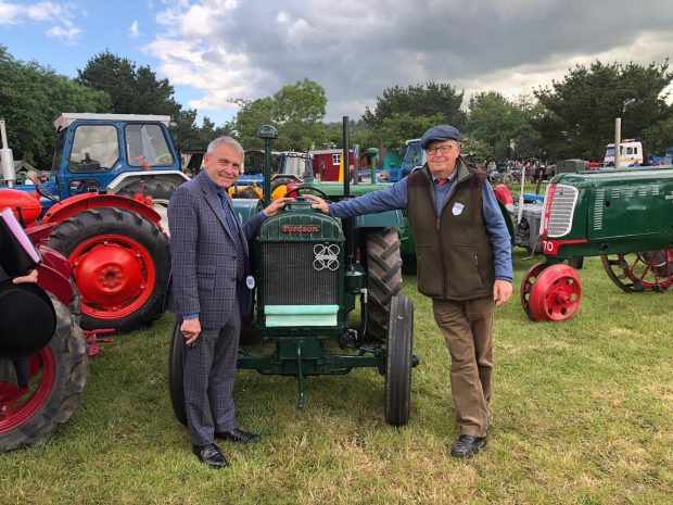 An image of Minister Goodwill at the show standing next to a tractor.