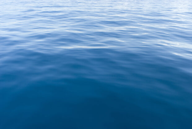 An image of background texture of the surface of blue water