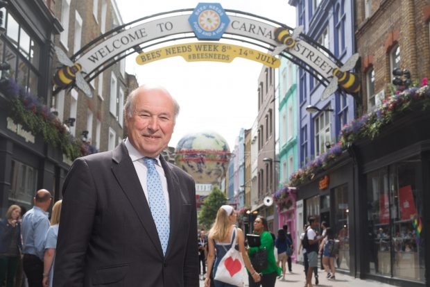 Lord Gardiner, Defra Biosecurity Minister, stands under the famous Carnaby Street which has been rebranded for Bees’ Needs Week with images of bees.