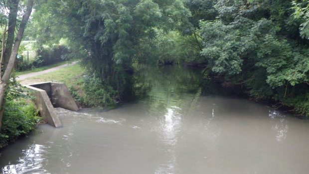 An image of sewage entering a river.