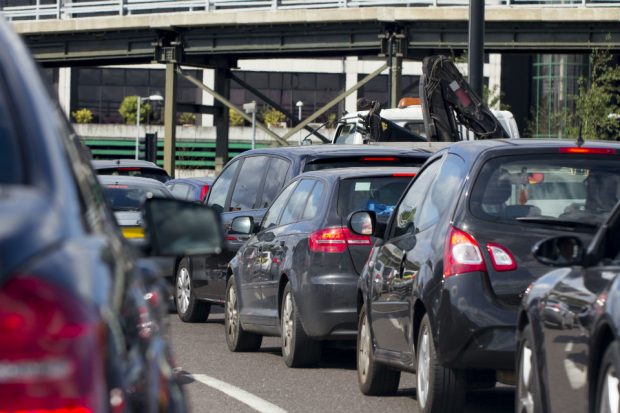 Picture showing a row of black cars in a traffic jam on a motorway