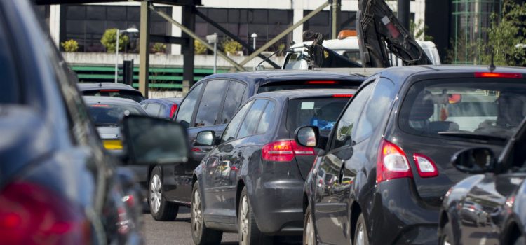 Picture showing a row of black cars in a traffic jam on a motorway