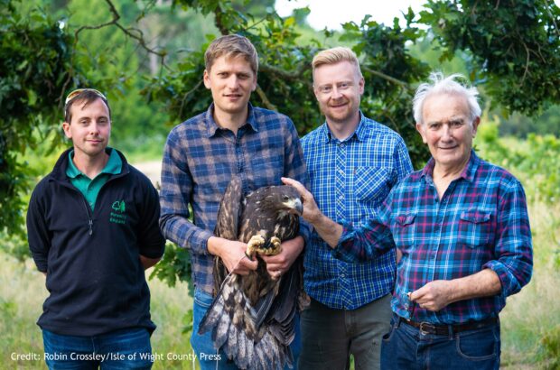 Four people stood holding one of the eagles