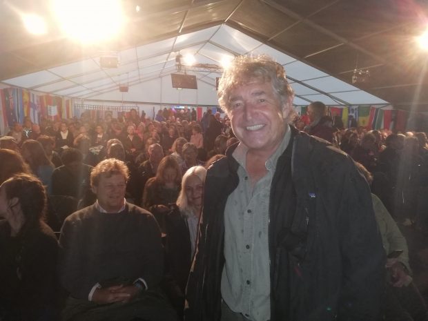 Tony Juniper, chairman of Natural England, standing on stage in front of a crowd in a tent at the Birdfair event at Rutland Water in Leicestershire