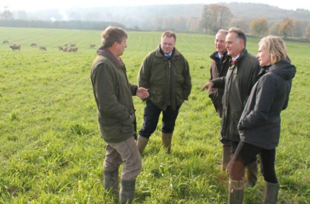 Marian Spain with the NFU and local farmers standing in a field talking