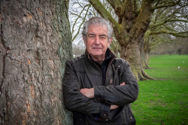 An image of Tony Juniper standing by a tree