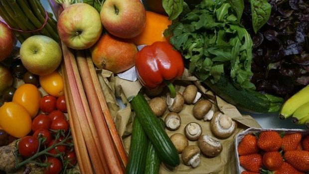 A selection of fruit and vegetables laid out on a table