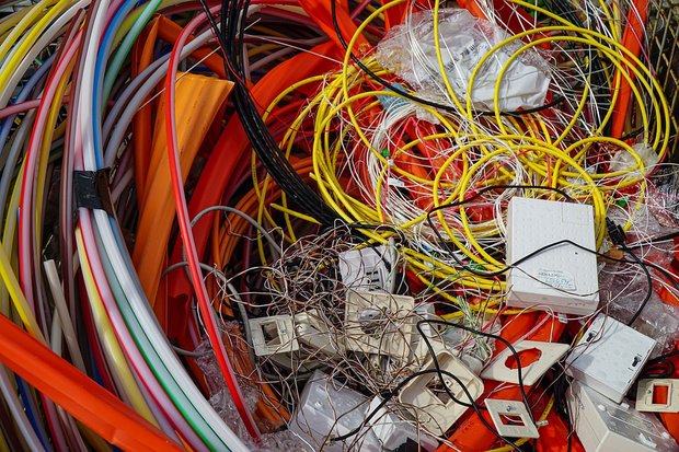 An image of various items of electrical waste including multi-coloured wires and circuit boards.