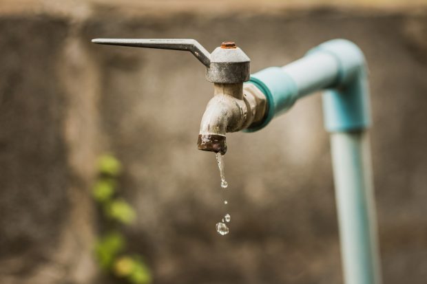 Faucet with a water drop / Water consumption concept