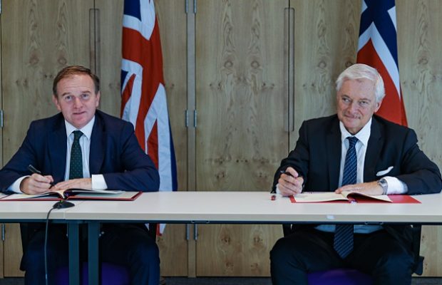 Environment Secretary George Eustice (left) and Norwegian Fisheries and Seafood Minister Odd Emil Ingebrigtsen (right) sign the historic UK-Norway Fisheries Framework Agreement