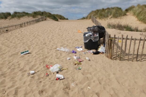 Image of an overflowing bin, showing litter on a UK beach