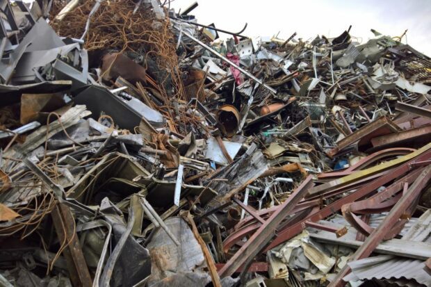 Scrap metal piled high in a junk yard