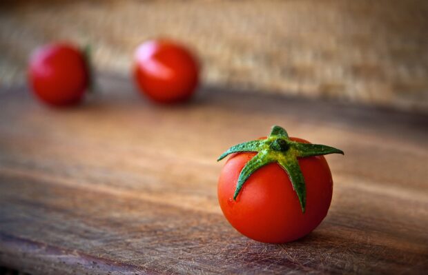Fresh tomatoes on wooden surface